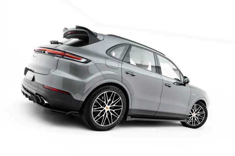 pol_po_Set-of-Splitters-Porsche-Cayenne-SUV-Mk3-Facelift-23886_13webp - OPSHOLDERS Rear-side view of a gray Porsche SUV with a prominent rear spoiler, red taillights, and large multi-spoke wheels and tires.