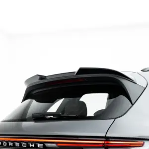Partial rear view of a silver Porsche SUV, showing the back window, spoiler, and a full-width red taillight strip with PORSCHE lettering behind.
