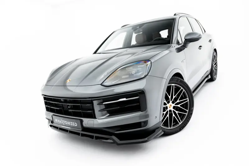 pol_po_Set-of-Splitters-Porsche-Cayenne-SUV-Mk3-Facelift-23886_16webp - OPSHOLDERS Silver Porsche SUV photographed from a front-left angle, showcasing the headlights, grille, and large alloy wheels in detail.