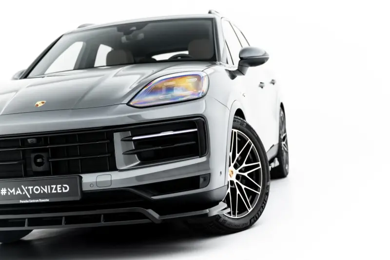 pol_po_Set-of-Splitters-Porsche-Cayenne-SUV-Mk3-Facelift-23886_2webp - OPSHOLDERS Front-left close-up of a silver Porsche, highlighting the headlight, grille, and stylish alloy wheel with a #MAXTONIZED plate visible on the bumper to left.