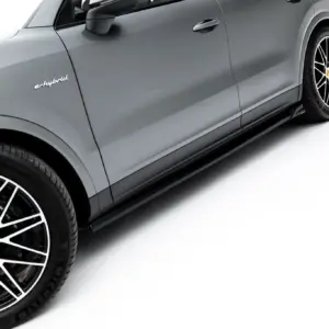 Side view of a gray Porsche SUV with the 'e-hybrid' badge and large multi-spoke wheels, cropped along the door and wheel area.