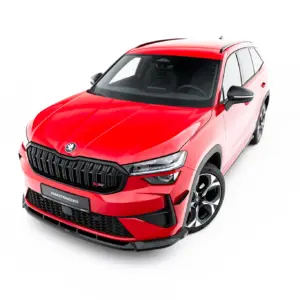 Red Skoda SUV viewed from the front-left, showing the grille, LED headlights and large alloy wheels.