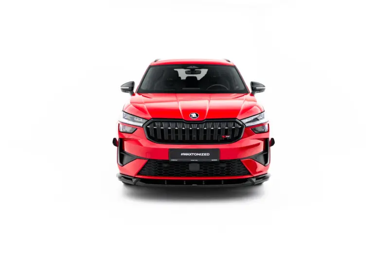 Front-facing view of a red Skoda SUV showing its bold grille, headlights, and emblem against a white studio background.