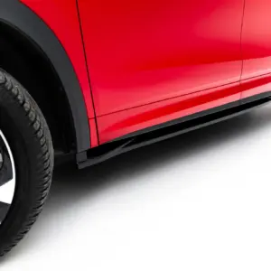 Close-up of a red car body with a visible alloy wheel and tire, highlighting glossy paint and curves.