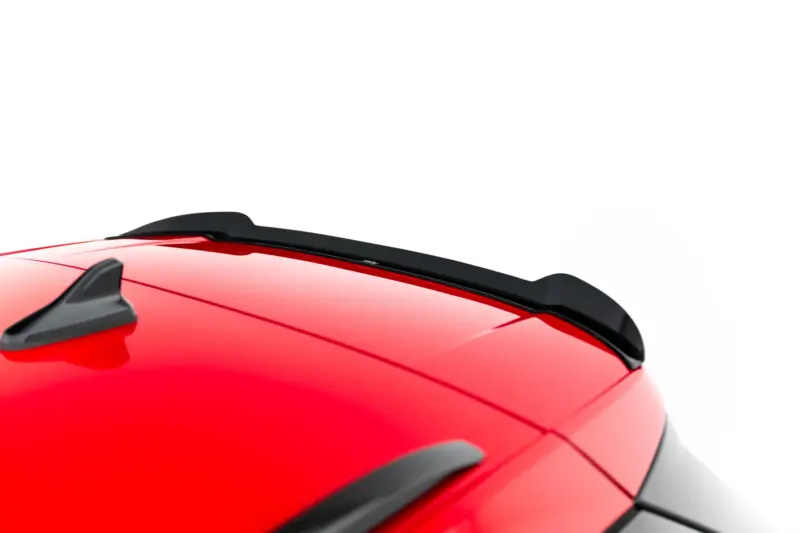 Close-up of a red car roof with black roof rails on a white background, highlighting the roof line and rack mounts.