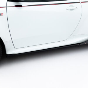 White car side panel with door handle, red side stripe, and black alloy wheel in foreground
