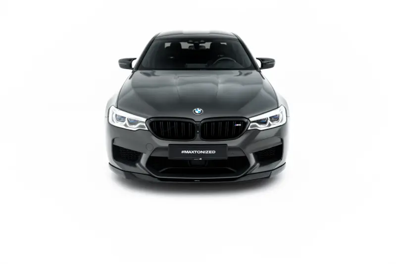 pol_po_Set-of-Splitters-V-1-BMW-M5-F90-23925_10webp - OPSHOLDERS Front view of a gray BMW M5, headlights on, black kidney grille, against a white background with #MAXTONIZED on the license plate area