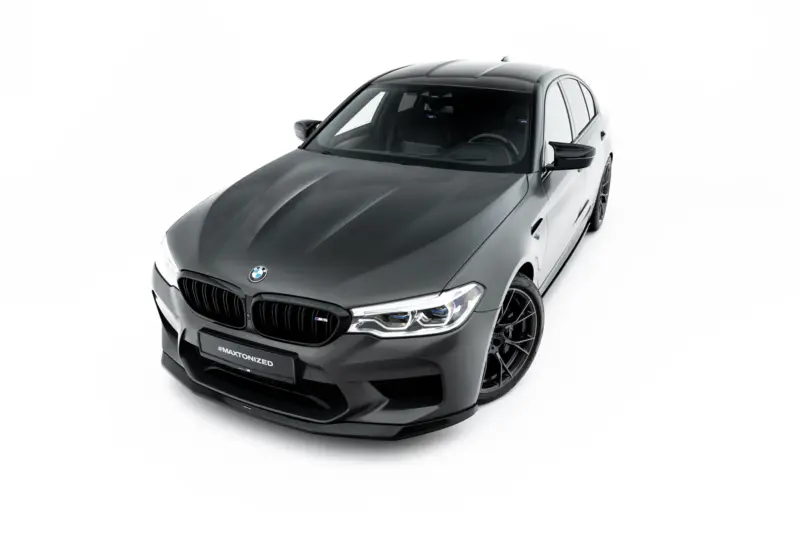 pol_po_Set-of-Splitters-V-1-BMW-M5-F90-23925_12webp - OPSHOLDERS Front three-quarter view of a dark gray BMW sedan with sporty wheels on a white studio background, showing the kidney grille and LED headlights.