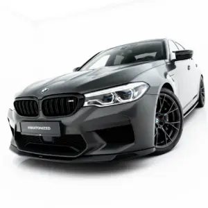 Close-up angled view of a glossy gray BMW M5 front end with signature kidney grille and LED headlights in a studio setting