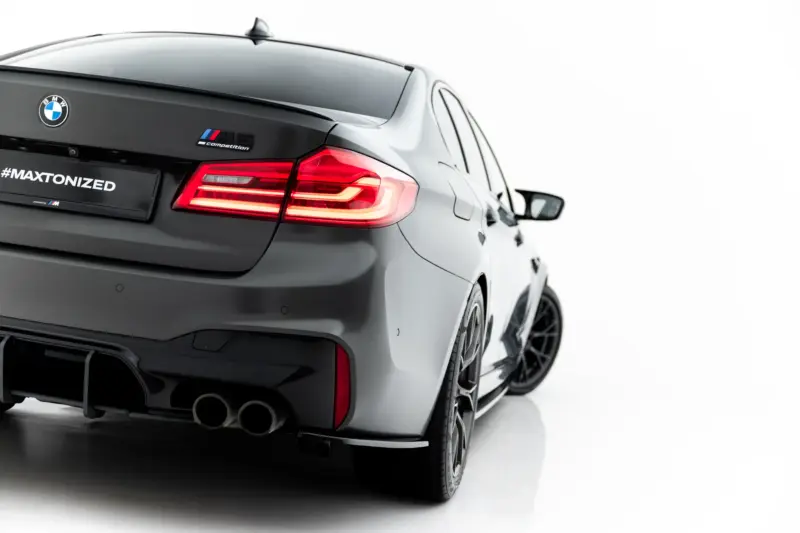 pol_po_Set-of-Splitters-V-1-BMW-M5-F90-23925_4webp - OPSHOLDERS Rear view of a gray BMW M competition with illuminated taillights and a '#MAXTONIZED' plate.