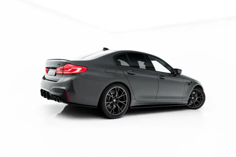 pol_po_Set-of-Splitters-V-1-BMW-M5-F90-23925_5webp - OPSHOLDERS Dark gray BMW M4 coupe shown from the rear three-quarter angle in a white studio setting, highlighting taillights and aftermarket wheels.
