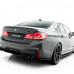 Rear view of a gray BMW M3 Competition with a '#MAXTONIZED' license plate, showcasing quad exhausts and red taillights on a white backdrop.