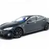 pol_po_Set-of-Splitters-V-1-Tesla-Model-S-Mk1-23948_2webp - OPSHOLDERS Dark gray Tesla Model S shown from a low front-left angle in a white studio backdrop, highlighting its sleek curves and large black wheels