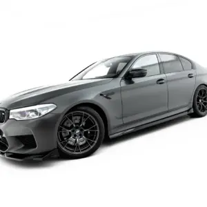 Gray BMW sport sedan angled to show the front and side, featuring large black alloy wheels, against a white studio background.