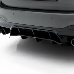 Rear view of a gray sports car showing quad exhaust outlets and a subtle diffuser with a Maxton Design badge