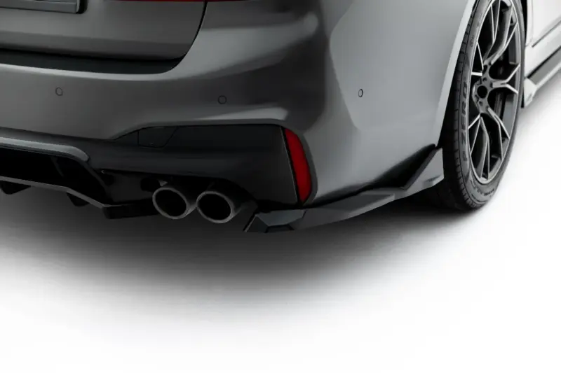 pol_po_Set-of-Splitters-V-2-BMW-M5-F90-23926_7webp - OPSHOLDERS Close-up of the rear left side of a dark gray sports car, featuring quad exhaust tips and a sculpted bumper.