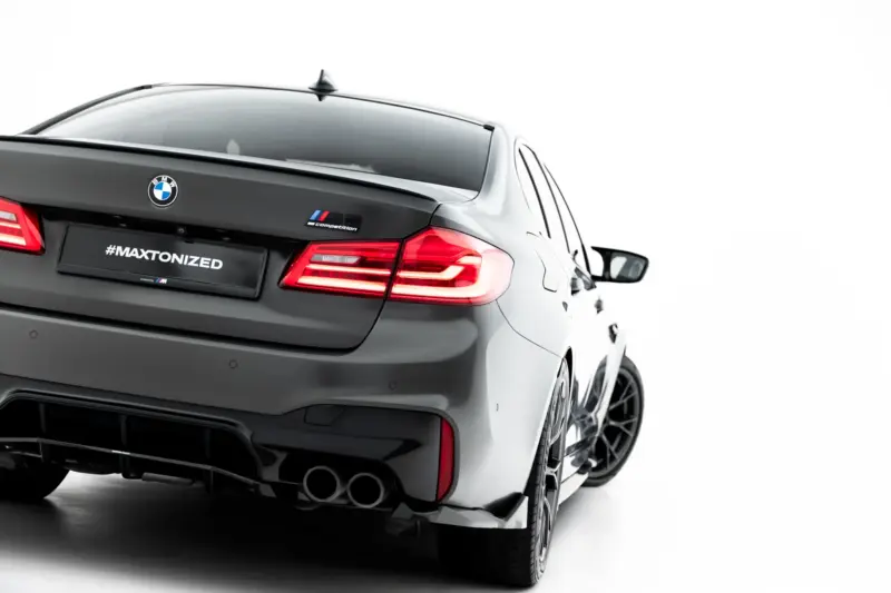 pol_po_Set-of-Splitters-V-2-BMW-M5-F90-23926_8webp - OPSHOLDERS Rear view of a gray BMW M car showing the M Competition badge and the #MAXTONIZED license plate area, with red taillights and dual exhausts visible.
