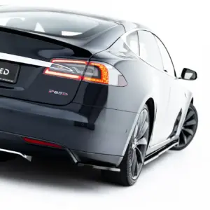 Rear view of a dark Tesla Model S showing taillights and a black license plate reading '#MAXTONIZED' on a white background.
