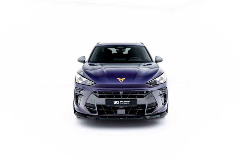 Front view of a metallic purple car in a bright studio, facing the camera, showing the grille, headlights, and a MAXTON DESIGN license plate badge.