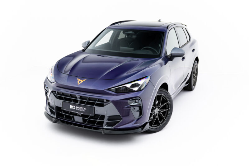 Front three-quarter view of a metallic purple SUV with bold grille and large alloy wheels in a studio setting.