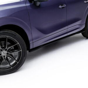Side view of a purple car with glossy paint and large black multi-spoke wheels.