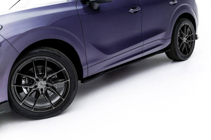 Side view of a purple car with glossy paint and large black multi-spoke wheels.