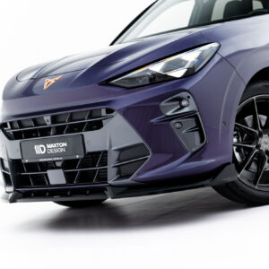 Close-up of a purple sports car front end, showing the headlight, grille, and alloy wheel.