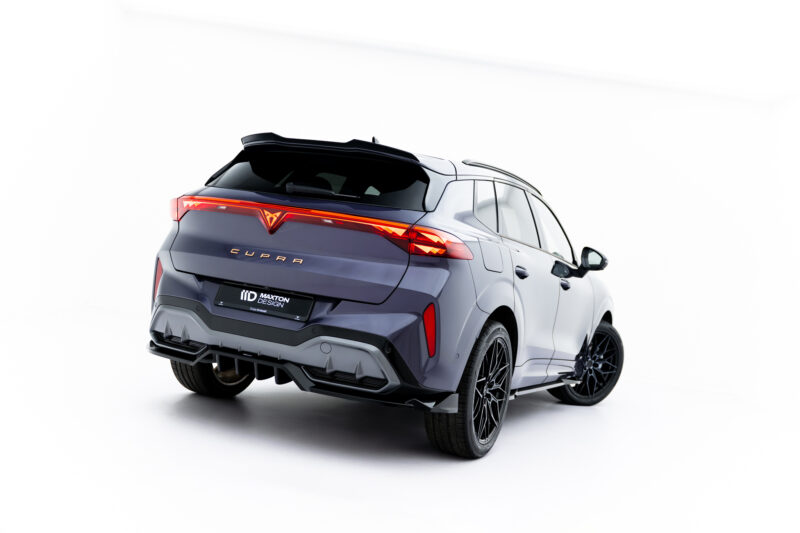 Rear three-quarter view of a metallic gray CUPRA SUV in a white studio, highlighting the distinctive redLED taillights and sporty rear design.