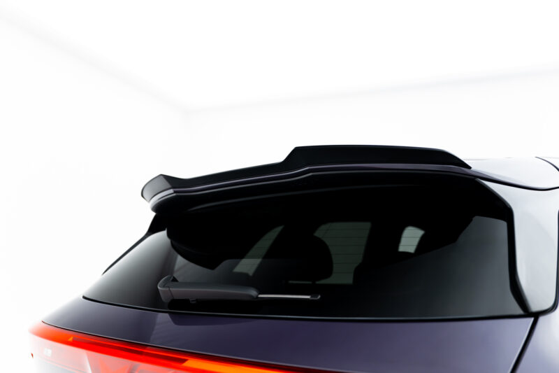 Rear portion of a white car showing the black rear window and a bright red taillight strip at the bottom edge, viewed from the left side.