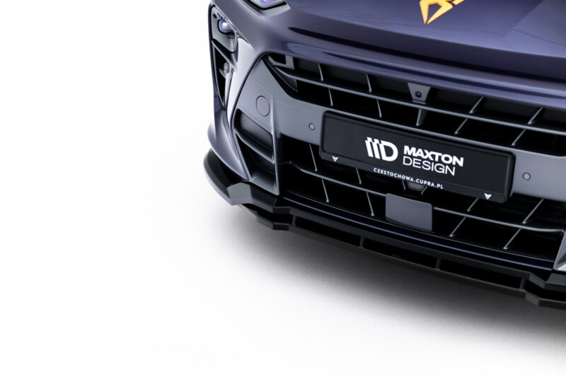 Close-up of the front end of a dark blue car showing the grille, bumper, and Maxton Design plate logo on the license area.