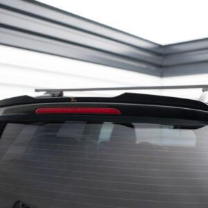 Rear view of a dark SUV with a roof rack crossbars mounted on top, above the rear window.