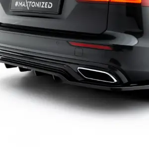 Close-up of the rear of a dark SUV, showing a red taillight, sleek bumper, exhaust, and a plate that reads '#MAYTONIZED'.