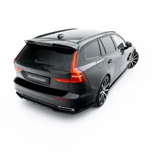 Three-quarter rear view of a gray Volvo SUV with a spoiler and sporty wheels, seen from above-right.