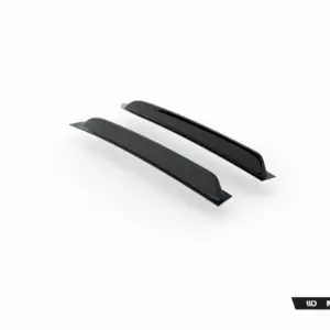 Pair of black car side skirts with an aerodynamic profile, displayed in a 3/4 view (Maxton Design branding).