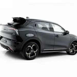 Rear three-quarter view of a dark gray modern SUV with large black and gold alloy wheels, against a white studio background.