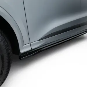 Side view of a metallic gray car body with a prominent wheel and quarter panel visible on a clean white background