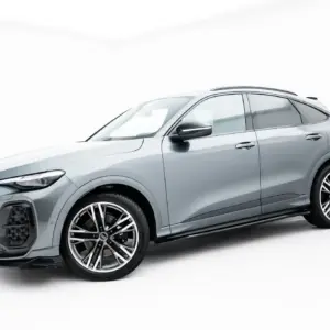 Silver Audi SUV shown from the front-left quarter on a white studio background, highlighting its grille and wheels.