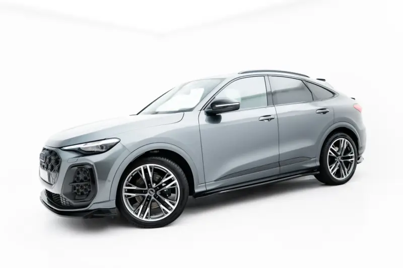 Silver Audi SUV shown from the front-left quarter on a white studio background, highlighting its grille and wheels.