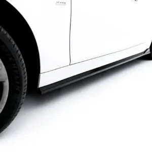Close-up of a white car's lower side panel with two wheels against a white background.