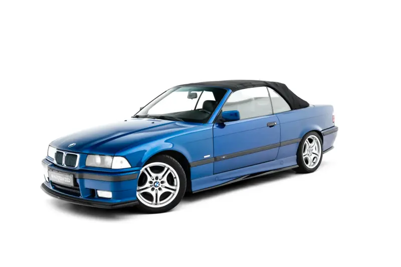 Blue BMW convertible with a black soft top, shown from the front-left angle against a white background for a clean product shot.