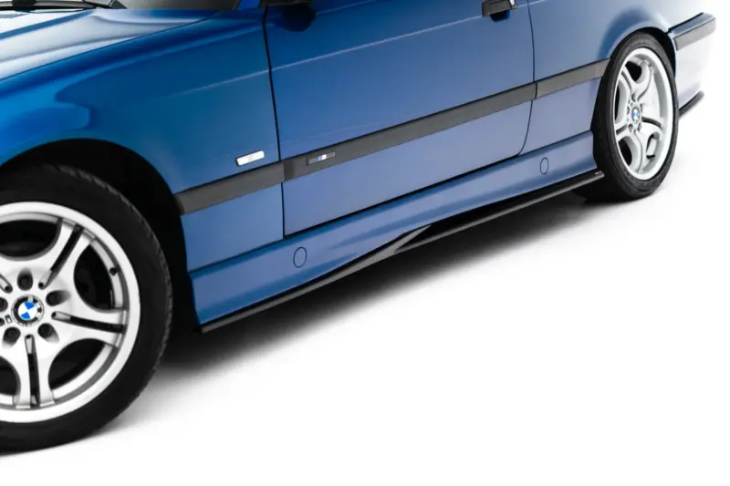 Blue BMW car side view showing door panel, black trim, and alloy wheel on white background.