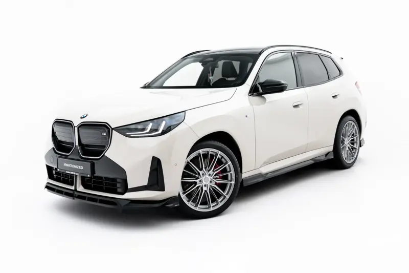 White BMW SUV photographed at an angle, showing front grille and large alloy wheels on a white background