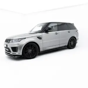 Silver Range Rover SUV with black wheels in a bright white studio backdrop, angled to show front and side profile.