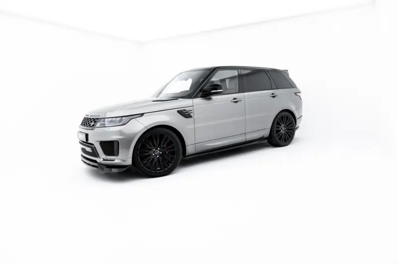 Silver Range Rover SUV with black wheels in a bright white studio backdrop, angled to show front and side profile.