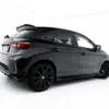 pol_po_Side-Skirts-Diffusers-MG-3-Mk1-23919_5webp - OPSHOLDERS Rear three-quarter view of a dark gray SUV with a raised rear spoiler and large black alloy wheels in a white studio setting.