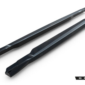 Pair of long, dark automotive aero strips (side skirts/extension pieces) shown diagonally on a white studio background; Maxton Design branding visible in the corner.