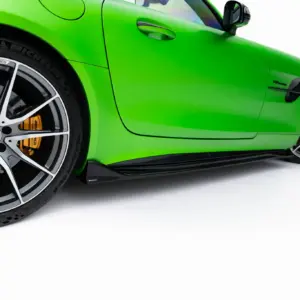 Close-up of a bright green sports car showing the front left wheel with a large silver alloy rim, orange brake caliper, and glossy bodywork.