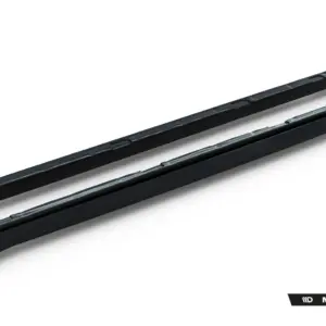 Two black car side skirts laid diagonally on a white background, with Maxton Design branding in the corner.