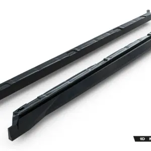 Two long black automotive side skirts with a glossy finish, displayed diagonally on a white background, with a Maxton Design logo in the bottom-right corner.