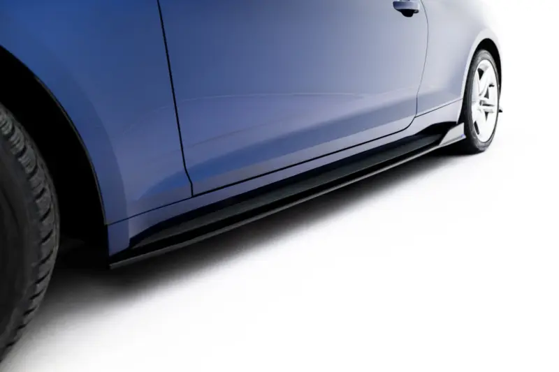 Close-up of a blue car's side panel with a visible door seam and wheel on the right, against a white background.